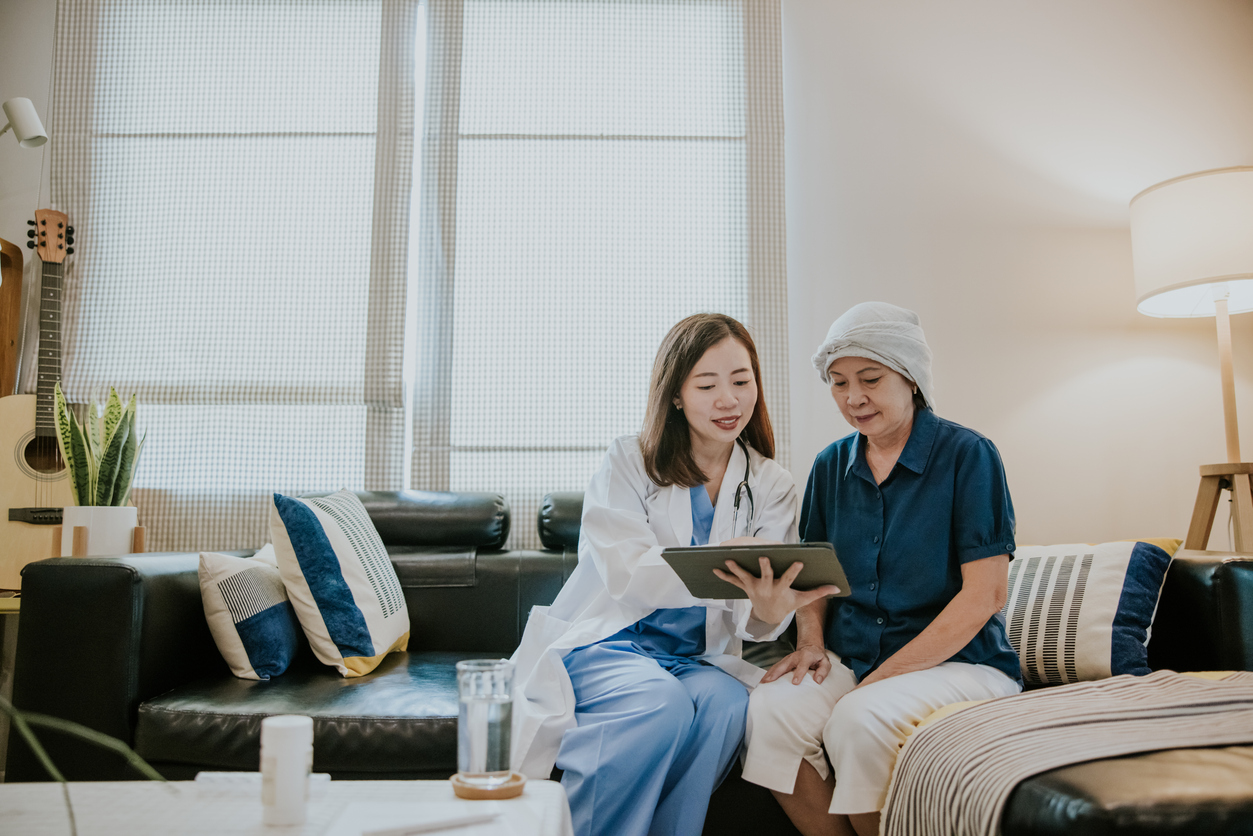 Female Doctor giving electronic prescription and explain more information after medical exam at home