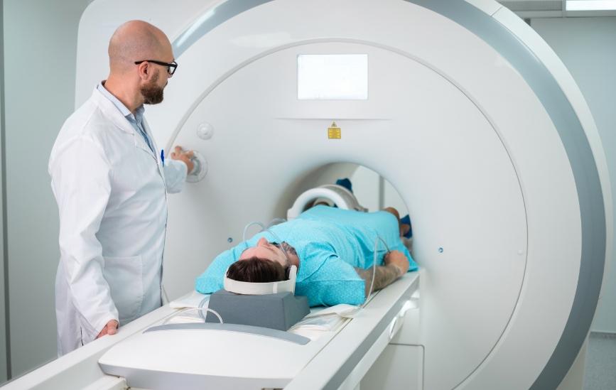 Doctor watching a patient get a CT scan 