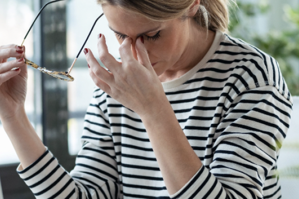 stressed woman in a black and white shirt