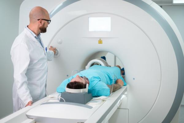 Doctor watching a patient get a CT scan 