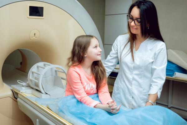 Child getting a brain scan by a doctor 