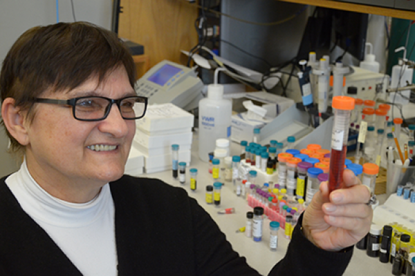 Dr. Batinic Haberle in her lab with a vial of BMX-001