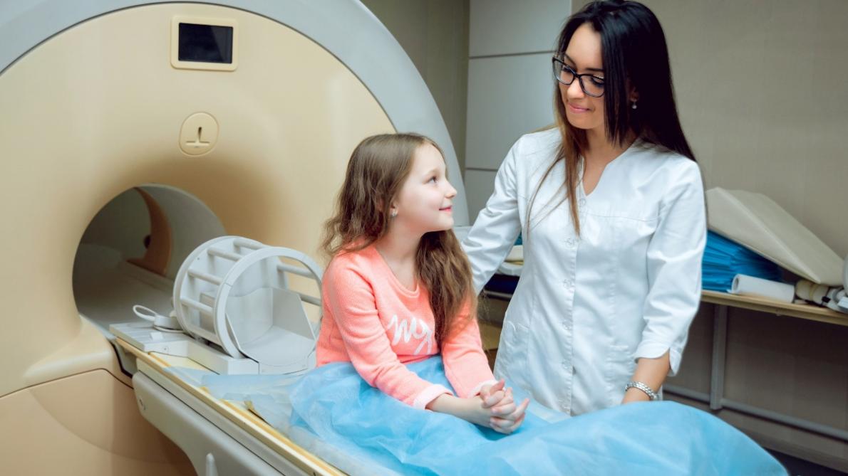 Child getting a brain scan by a doctor 
