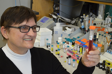 Dr. Batinic Haberle in her lab with a vial of BMX-001