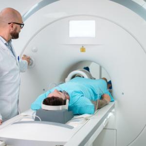 Doctor watching a patient get a CT scan 