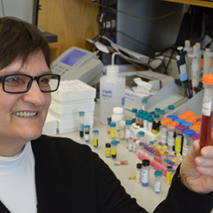 Dr. Batinic Haberle in her lab with a vial of BMX-001